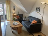 Ferienwohnung in Fehmarn OT Petersdorf - Ferienwohnung Bartels Kiebitzweg mit Balkon - Wohnzimmer mit Balkonzugang